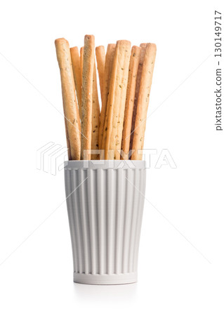 Crispy grissini breadsticks in cup isolated on white background. 130149717