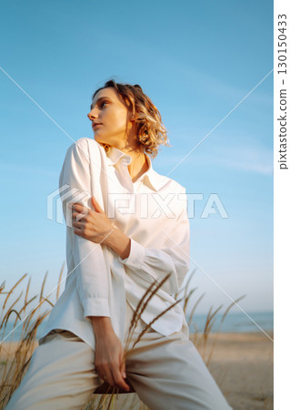 Stylish woman enjoying autumn weather outdoor. Fashion, style concept. People, lifestyle, relaxation 130150433