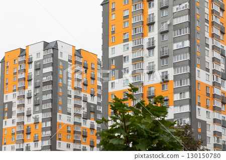 Modern high-rise apartment buildings in a vibrant residential area, showcasing urban living options 130150780