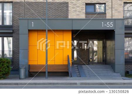 Modern residential entrance of high-rise apartment building in urban area emphasizing rental and 130150826