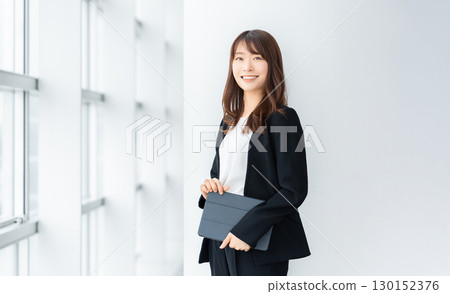 Smiling woman/businesswoman holding a tablet Smiling woman/businesswoman holding a tablet 130152376