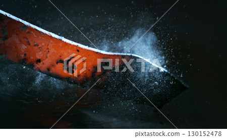 Blacksmith puts the red-hot forged metal part into cold water , close-up 130152478