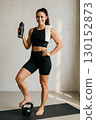 A confident athletic woman holding a water bottle 130152873