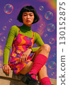 A woman in vibrant 70s-style fashion posing outdoors 130152875