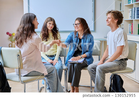 Teenage students and female psychologist during group therapy session 130152955