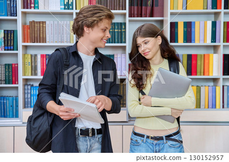 Portrait of two teenage students classmates boy and girl talking at school Portrait of two teenage students classmates boy and girl talking at school 130152957
