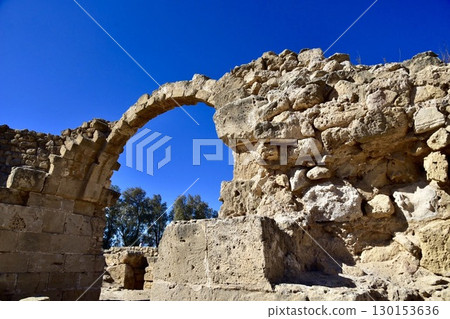 Ancient arch ruins in Cyprus, shining against the blue sky 130153636