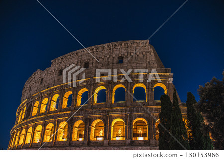 Night view of the illuminated Colosseum with glowing arches in Rome, Italy 130153966