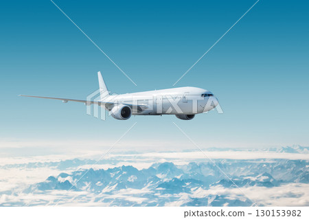 White wide body passenger airplane flying in the air over snow covered mountains 130153982
