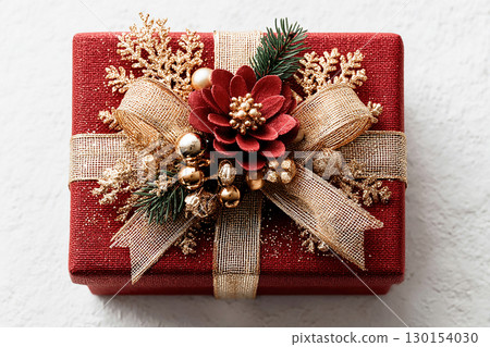 Holiday gift. Christmas Gift Box with a sprig of pine on white background. Christmas traditions and seasonal joy. 130154030