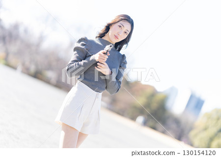Woman holding a pistol 130154120