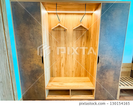Wardrobe with hangers. Storage, organization, and hotel room furniture. 130154165