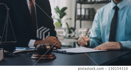 Lawyer explained to the client about the law that must be brought against the court case. Lawyer explained to the client about the law that must be brought against the court case. 130154310