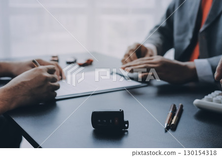 Car salesman gave the keys to the customers who signed the purchase contract legally, Successful completion of car sales, Purchase contract and key delivery. 130154318