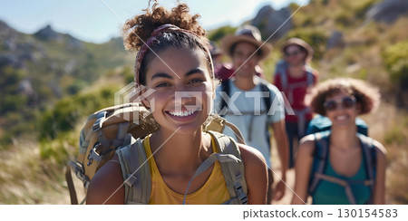 Smiling woman hiker with backpack looking at camera with group of friends hikers background, World Tourism Day - Ai Generated 130154583