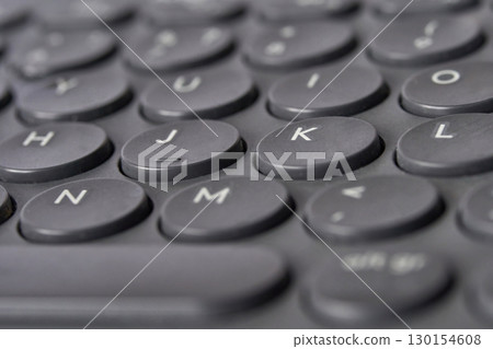 Close up of black computer keyboard with round keys for vintage aesthetic 130154608