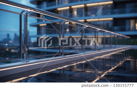 Sleek modern glass and stainless steel balcony railing illuminated at night with city view Sleek modern glass and stainless steel balcony railing illuminated at night with city view 130155777