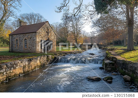 Picturesque Stone Building by Flowing Stream in a Tranquil Autumn Setting 130155868