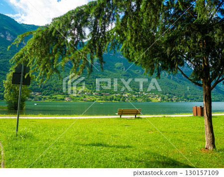 Crone public park with empty benches on Lake Idro, Lombardy, Italy. 130157109