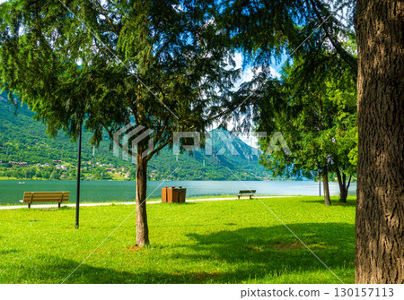 Crone public park with empty benches on Lake Idro, Lombardy, Italy. 130157113