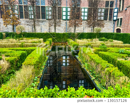 Green Maze Garden with Reflecting Pool Amidst Historic Architecture and Nature 130157126