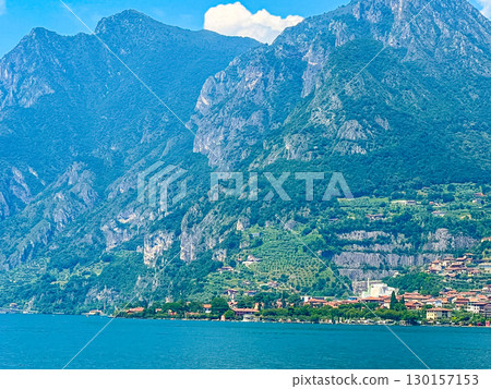 View of Iseo Lake Surrounded by Majestic Mountains and Clear Blue Skies, Italy View of Iseo Lake Surrounded by Majestic Mountains and Clear Blue Skies, Italy 130157153