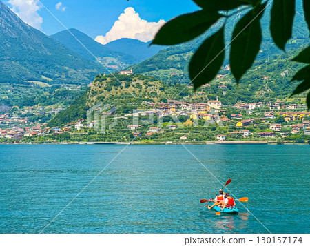 Adventurous Individuals Kayaking on a Scenic Lake Surrounded Mountains and Trees Adventurous Individuals Kayaking on a Scenic Lake Surrounded Mountains and Trees 130157174