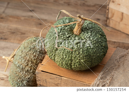 Buen Gusto de Horno Heirloom Pumpkins on Wooden Crate Buen Gusto de Horno Heirloom Pumpkins on Wooden Crate 130157254
