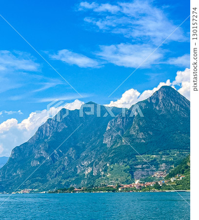 View of Iseo Lake Surrounded by Majestic Mountains and Clear Blue Skies, Italy View of Iseo Lake Surrounded by Majestic Mountains and Clear Blue Skies, Italy 130157274