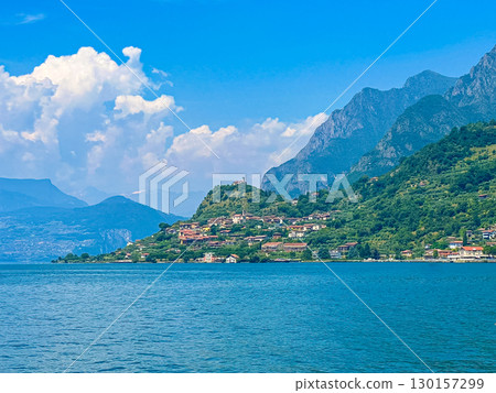 View of Iseo Lake Surrounded by Majestic Mountains and Clear Blue Skies, Italy 130157299