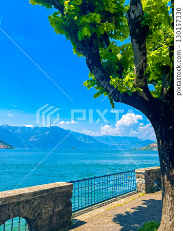 View of Iseo Lake Surrounded by Majestic Mountains and Clear Blue Skies, Italy 130157330