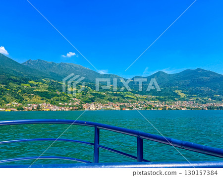 View of Iseo Lake Surrounded by Majestic Mountains and Clear Blue Skies, Italy View of Iseo Lake Surrounded by Majestic Mountains and Clear Blue Skies, Italy 130157384