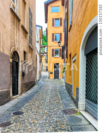 Traditional buildings with balconies, shutter windows and colored walls, Brescia 130157385