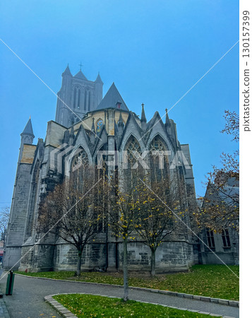 Gothic cathedral of Ghent against a stunning blue sky background 130157399