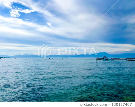 Stunning view over the Garda lake, seen from Peschiera del Garda. Summer day. Stunning view over the Garda lake, seen from Peschiera del Garda. Summer day. 130157407
