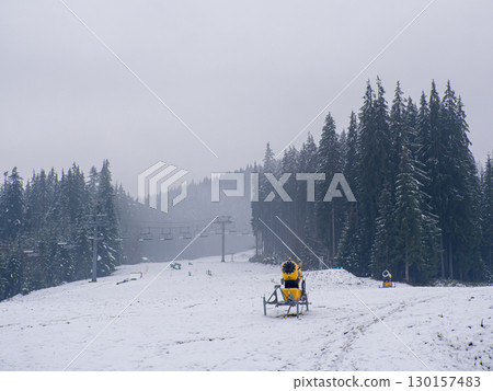 snow cannon for the production of artificial snow in the mountains 130157483