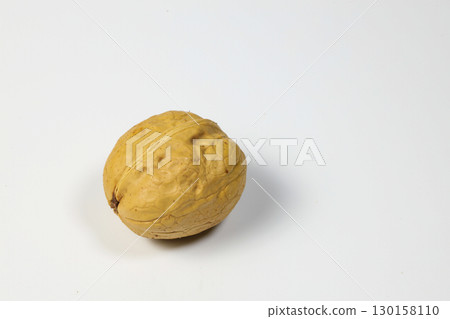Unpeeled walnuts on white background. Walnut nut with shell. Unpeeled walnuts on white background. Walnut nut with shell. 130158110
