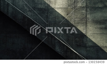 Concrete wall with diagonal shadows creating an artistic pattern in natural light 130158439