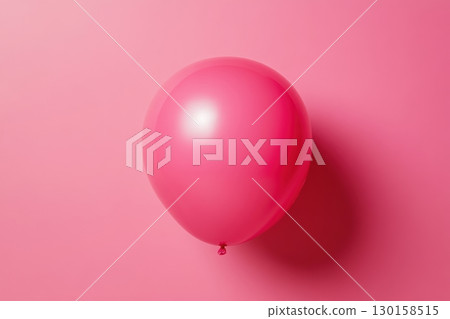 Pink balloon floating gently against a vibrant pink background, creating a cheerful and playful atmosphere Pink balloon floating gently against a vibrant pink background, creating a cheerful and playful atmosphere 130158515