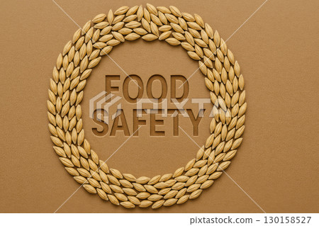 Food safety concept with barley grain arranged in circular shape on brown background, symbolizing healthy and secure food production and consumption 130158527