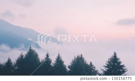 Mountain landscape at dawn with mist flowing through trees and soft pastel sky colors 130158775