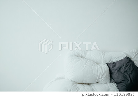 Cozy white sofa with a gray cushion in a bright, minimalistic living room 130159055