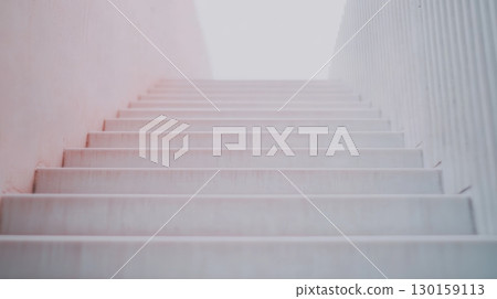 Staircase leading to bright light at the top in modern architecture 130159113