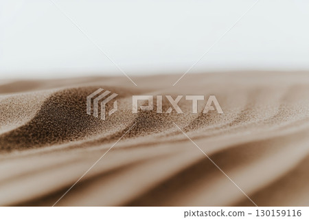 Soft contours of golden sand dunes under bright sunlight create a serene landscape in the desert 130159116