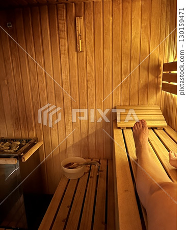 Relaxing Wooden Sauna Interior, Wooden sauna interior with pebbles in a wooden box Relaxing Wooden Sauna Interior, Wooden sauna interior with pebbles in a wooden box 130159471