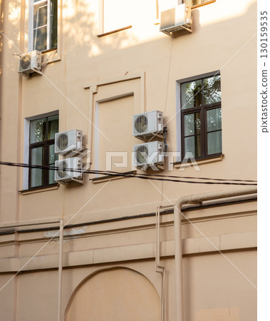 air conditioners are installed on the wall of the building. cooling in hot weather. air conditioners are installed on the wall of the building. cooling in hot weather. 130159535