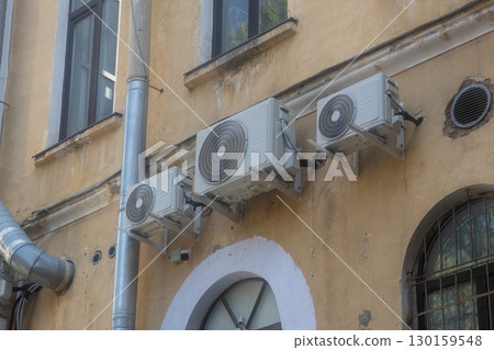 Air conditioners are installed on facade of building. device for comfortable living in hot weather. Air conditioners are installed on facade of building. device for comfortable living in hot weather. 130159548