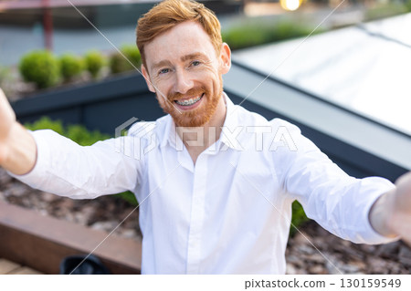 Handsome bearded man with ginger hair dressed in white shirt capturing pov selfie Handsome bearded man with ginger hair dressed in white shirt capturing pov selfie 130159549