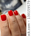 Female hand with red manicure, nail design, christmas manicure 130159579
