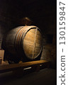 A historic wine cellar with an antique wooden press, grape crusher, and giant barrel. The concept is traditional winemaking heritage and craftsmanship. 130159847
